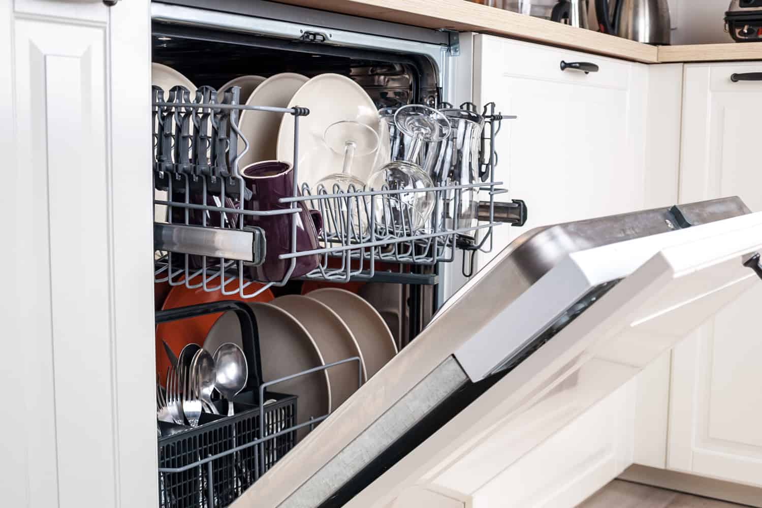 dishwasher close-up with washed dishes, easy to use and save water, eco-friendly, built-in kitchen dish washing machine