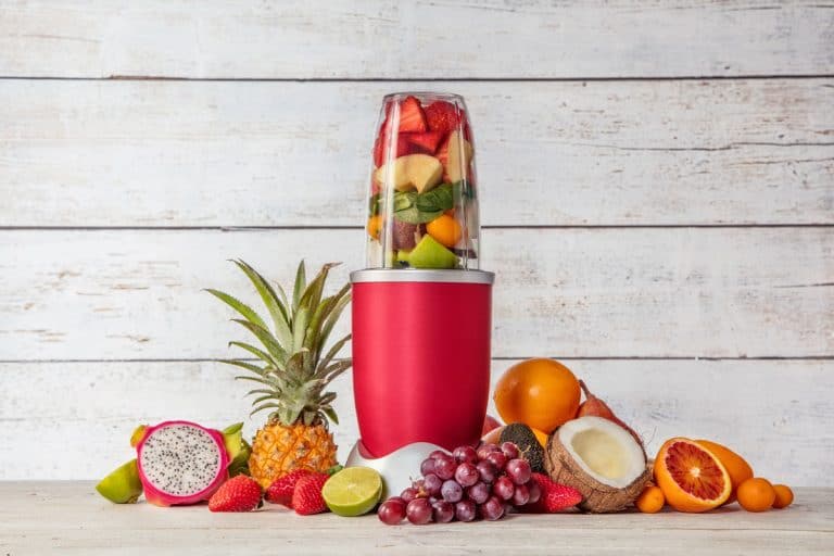 Nutribullet with sliced fruits inside and fruits on the side, ,How Long Does The Nutribullet Last?