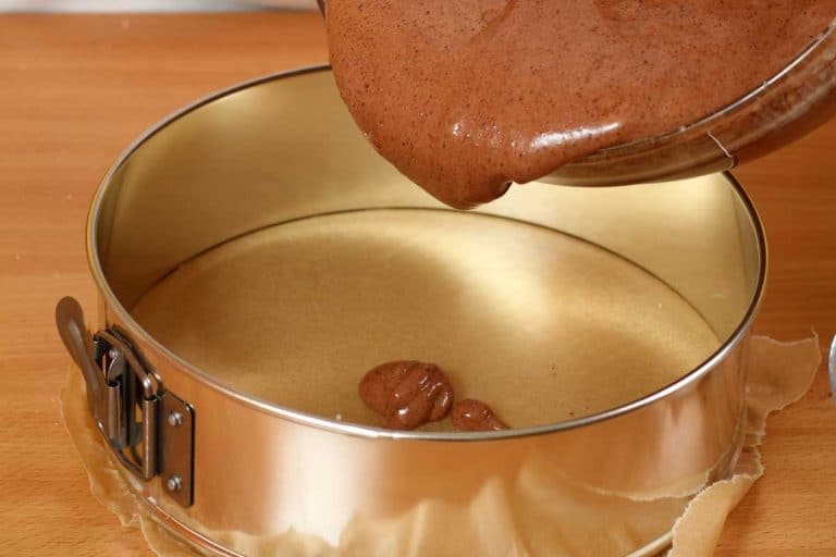 Person pouring cake mix into springform tin, Do You Need To Line A Springform Cake Tin?