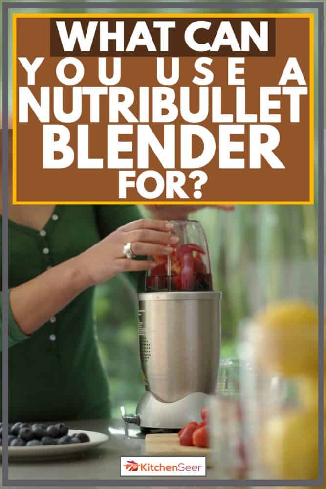 女人在她搅拌机混合很多品种的水果,你可以使用一个Nutribullet搅拌机?