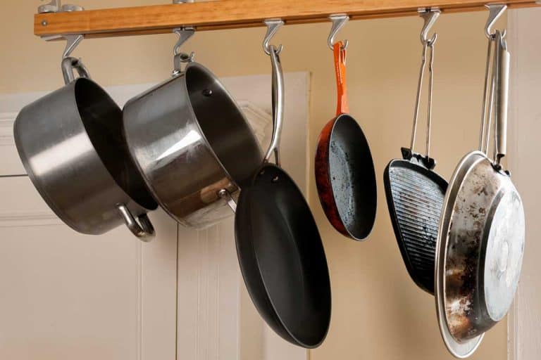 Modern kitchen with a rack of hanging pots and pans, Where Should You Store Heavy Pots? [8 Options Explored]