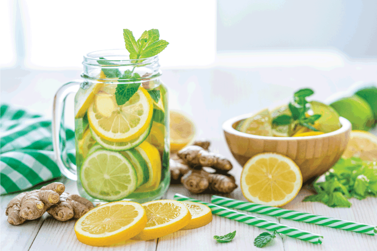 Some-lemon-slices,-ginger-roots-and-two-green-and-white-drinking-straws.-Does-Microwaving-Lemons-And-Lime-Make-Them-Juicier