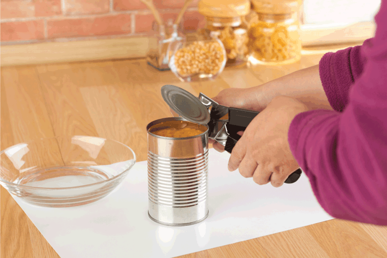 woman-opening-a-can-of-corn-with-can-opener-in-the-雷电竞官网网址kitchen.-How-Long-Should-A-Can-Opener-Last
