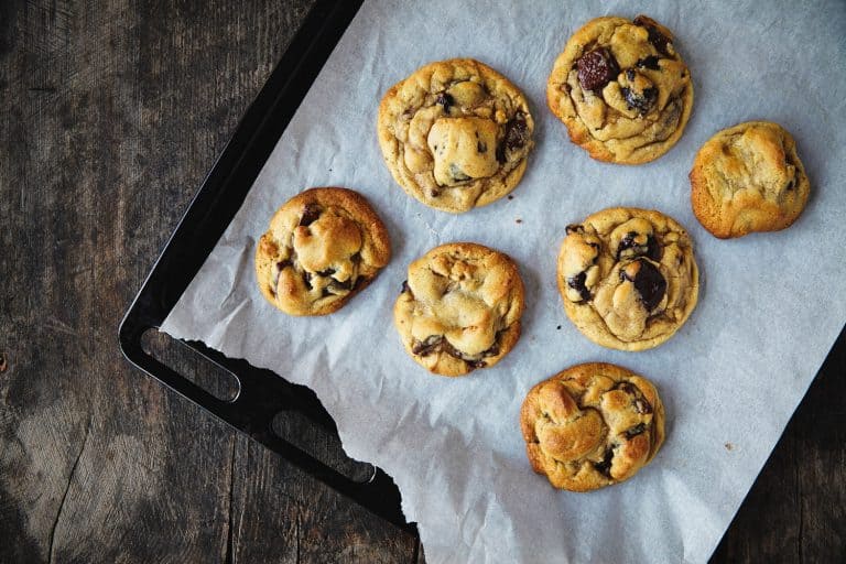 Freshly baked cookies placed under a black cookie sheet, Is A Cookie Sheet Non-Stick?