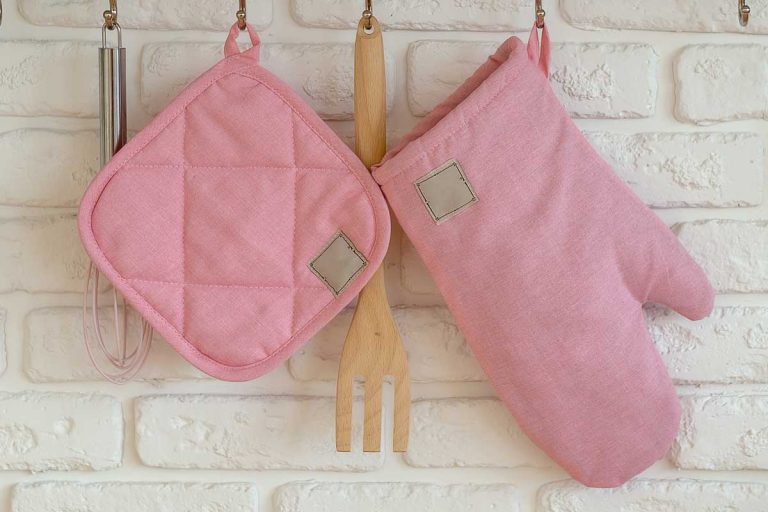 雷电竞官网网址厨房手套,防烫套垫,烤箱保护笼罩在白色砖墙,布垫子和微波炉手套——差异是什么?