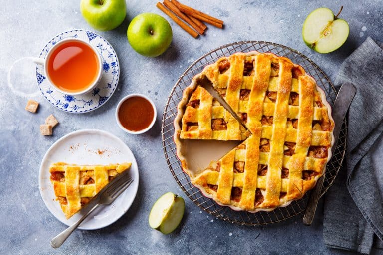 Apple pie on a cooling rack. Grey background. Can You Bake Apple Pie In A Cake Pan?
