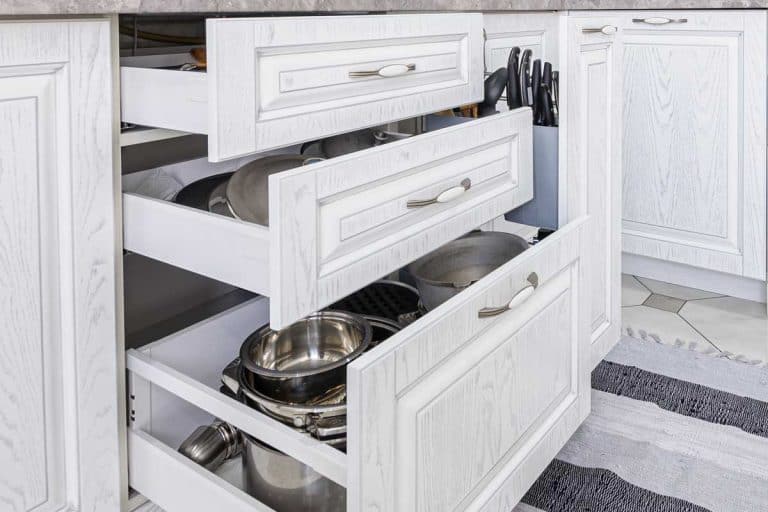 Drawers open in modern white wooden kitchen, Kitchen Drawers Open By Themselves - What To Do?