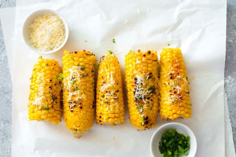 Grilled corn cobs grated with cheese and chives, 5 Ways To Reheat Corn On The Cob