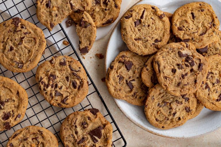 Overhead of chocolate chip cookies on a plate and cooling rack, 15 Types Of Chocolate Chip Cookies