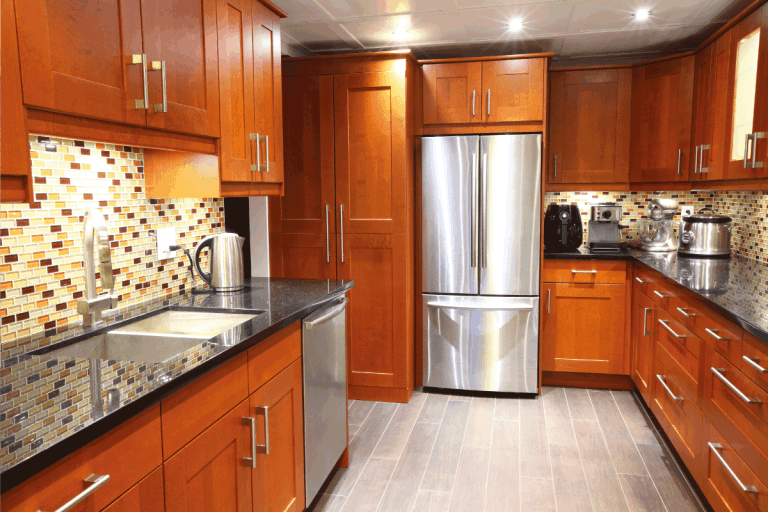 Modern-luxury-雷电竞官网网址kitchen-with-stainless-steel-appliances、-mosaic-backsplash -black-galaxy-granite-counter-tops.-How-To-Lubricate-A-Trash-Compactor