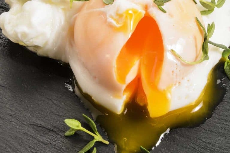 Open organic poached egg with thyme on slate, How To Poach An Egg With A Ladle - All You Need To Know!