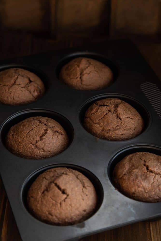 Freshy baked chocolate cupcakes in a dark pan