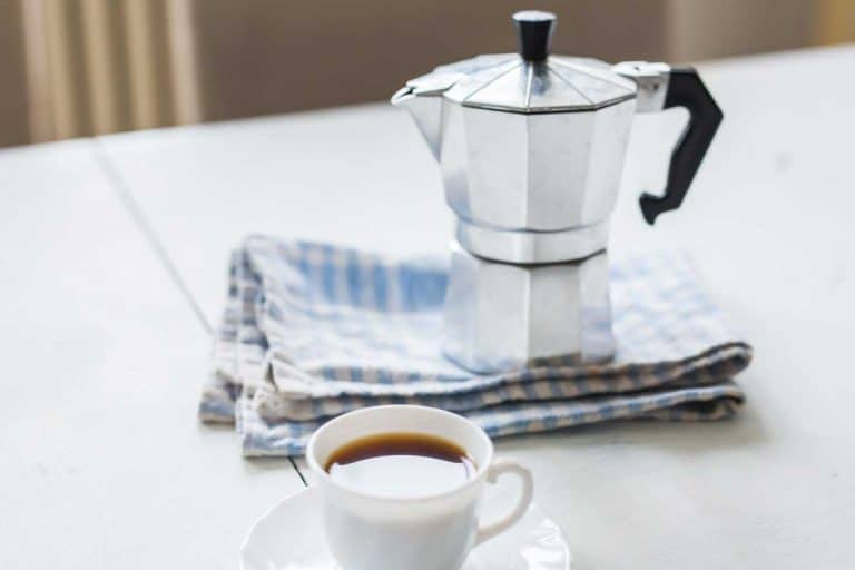 Stainless steel coffee percolator and a cup of coffee on the table, How To Clean A Stainless Steel Coffee Percolator