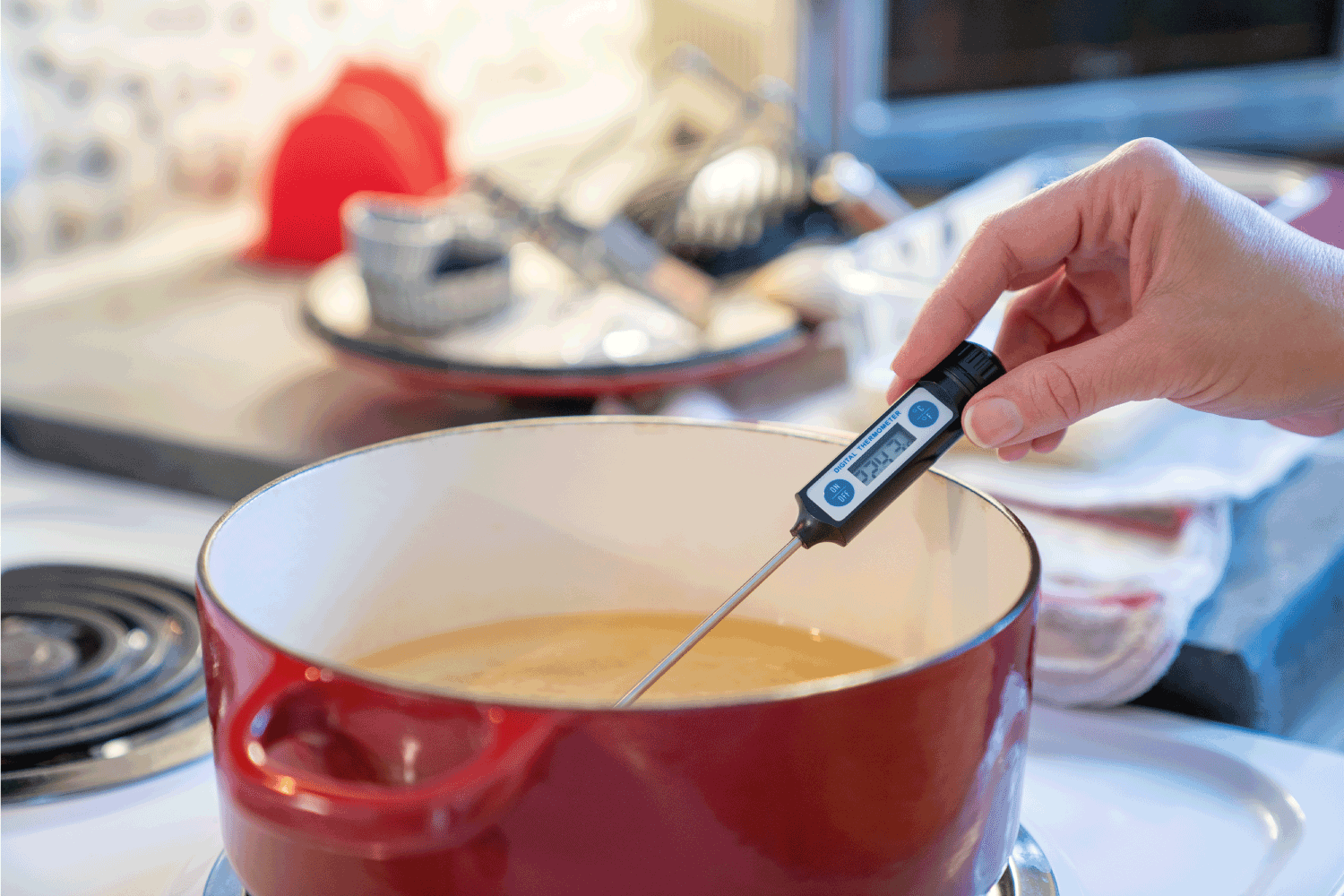 厨师在荷兰烤肉锅测量油温。你能在荷兰炒炉(以及如何)