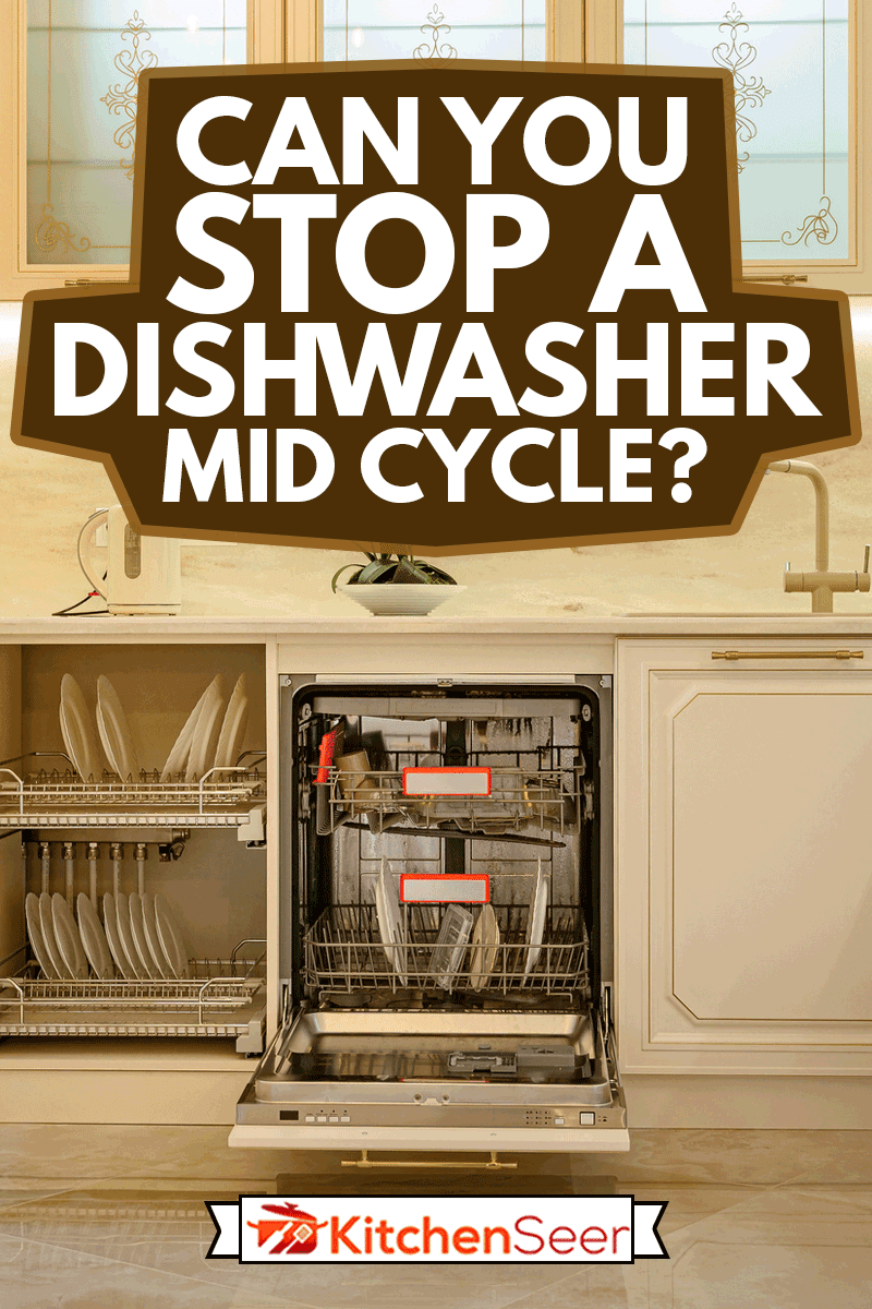 大型豪华米色和黄金经典厨房室内与家具在普罗旺斯风格,橱柜门和洗碗机是开放雷电竞官网网址的,你能阻止一个洗碗机中期周期吗?