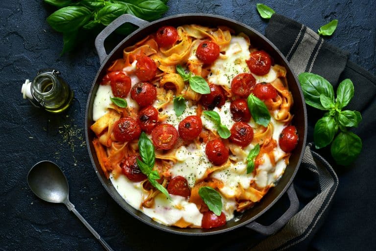 A pasta casserole with tomatoes, basil and mozzarella cheese inside a pot, What's The Best Pot For Cooking Vegetables?