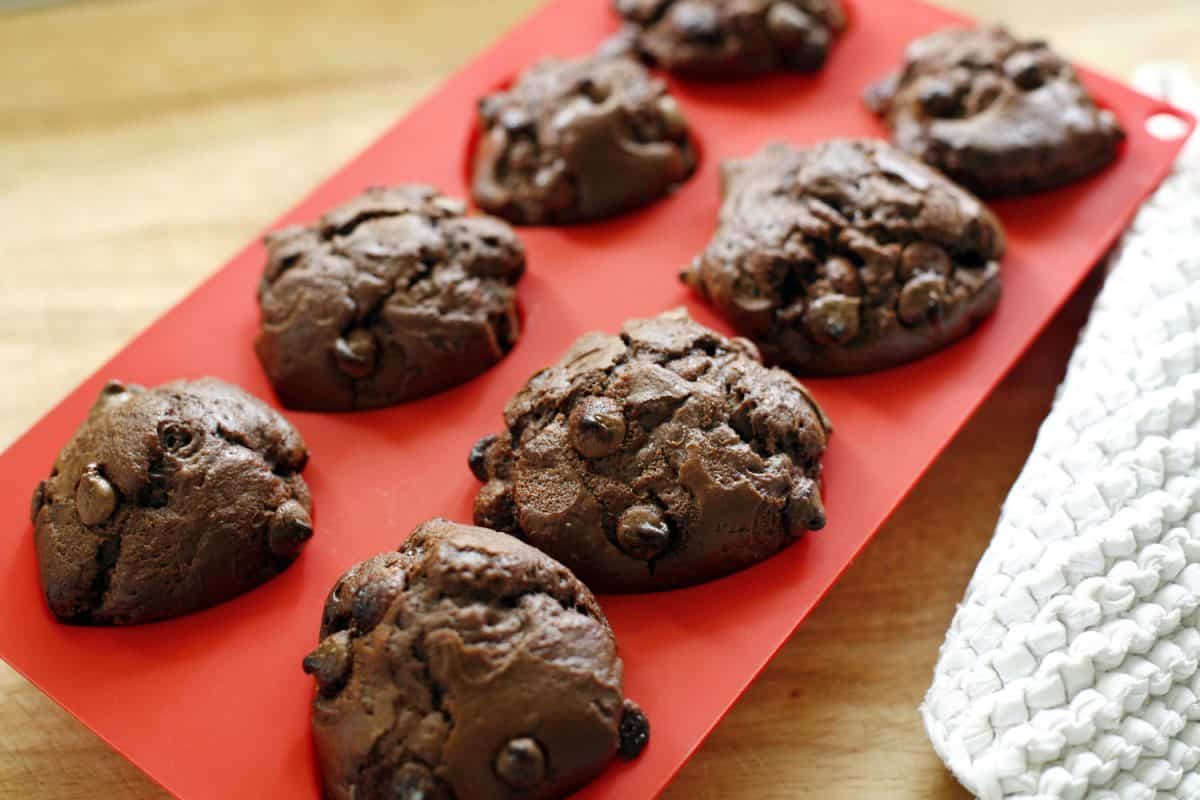 Process of cooking delicious homemade muffin and Halloween cupcake. Woman preparing and mixing ingredients for sweet food dessert in kitchen at home