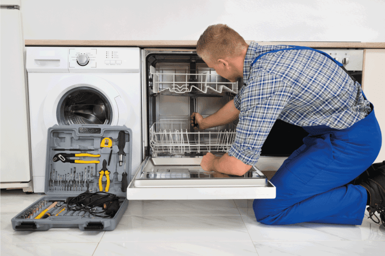 Young-Man-In-Overall-With-Toolbox-Repairing-Dishwasher.-GE-Dishwasher-Beeps-Every-60-Seconds-What-To-Do