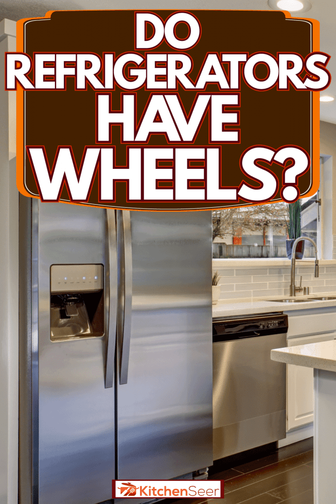 一个宽敞的厨房早餐酒吧雷电竞官网网址悬挂灯,冰箱角落,冰箱有轮子吗?