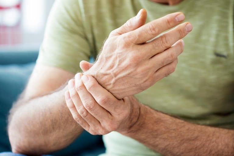 An old man suffering from pain and rheumatism, What Are The Best Drinking Glasses For Arthritic Hands?