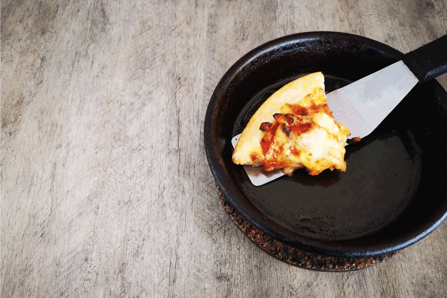 Serving hot pizza on hot pad