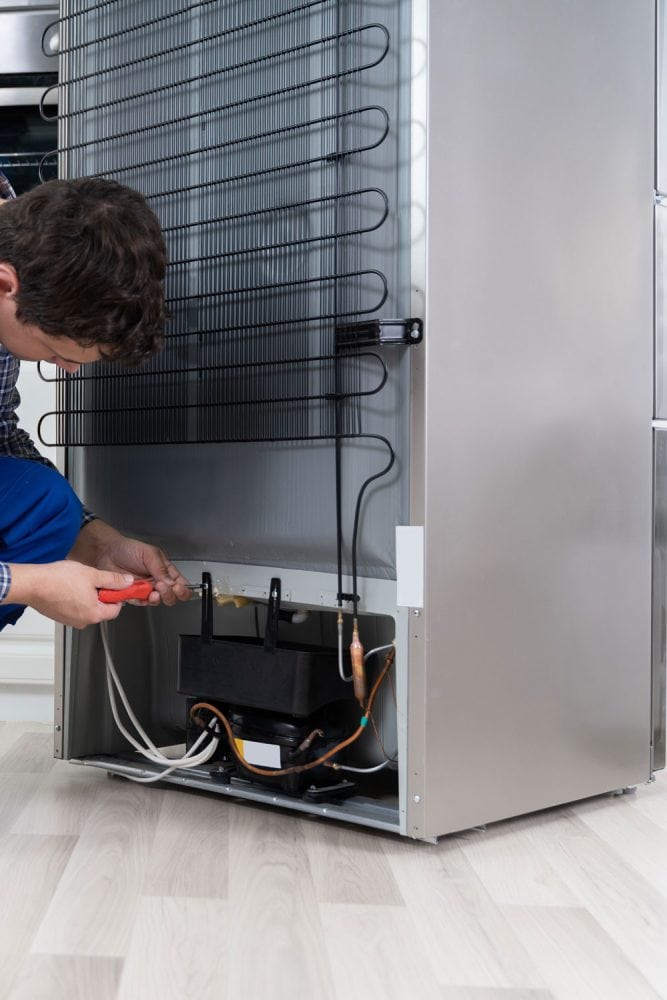 技术员检查冰箱的散热器