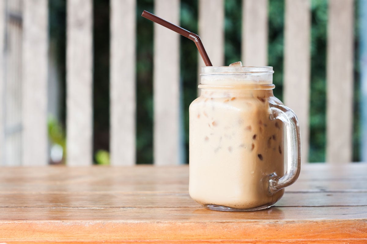 Glass of iced coffee on wooden table