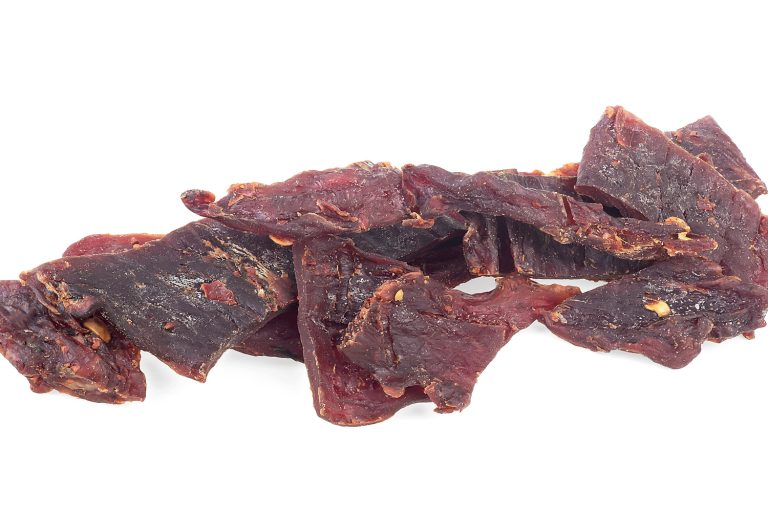 Portion of spices beef jerky pieces isolated on a white background - How Long Does Deer Jerky Last