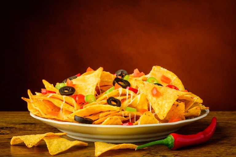 still life with baked nachos, cheese, olives and chili peppers, At What Temperature To Bake Nachos