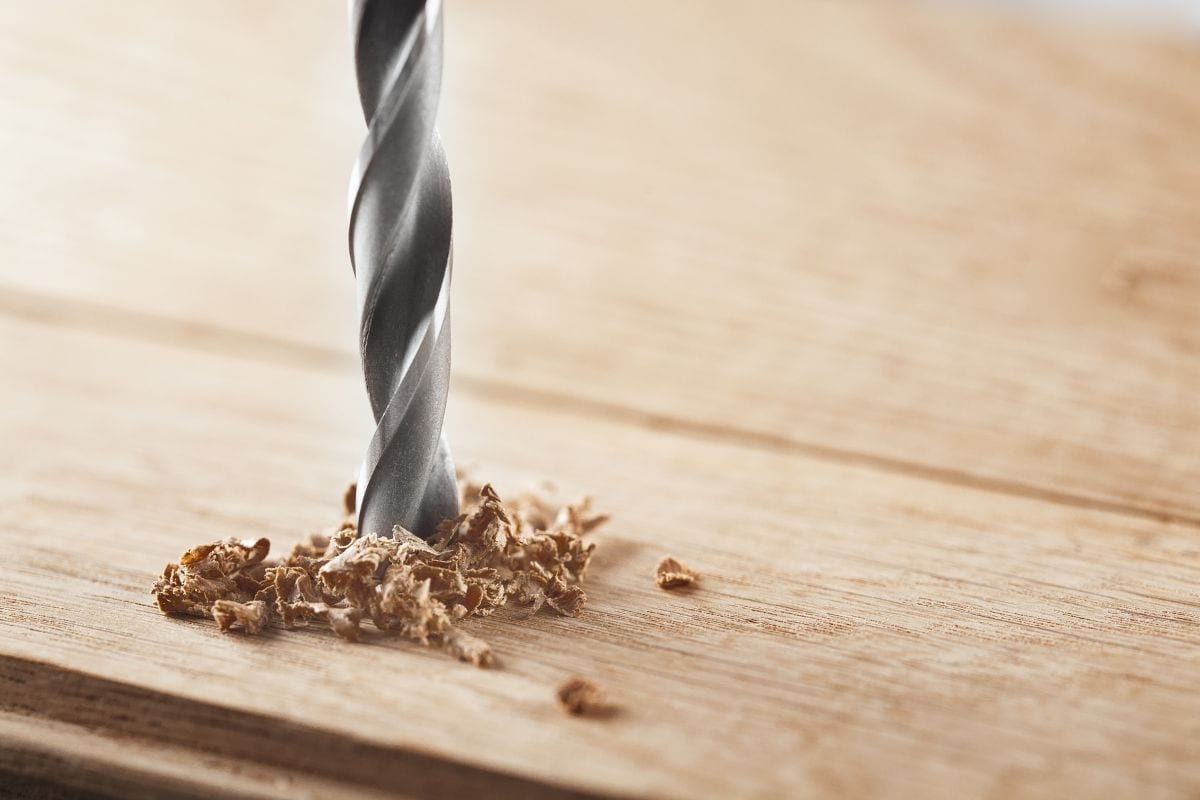 金属钻头在橡木木板上钻洞