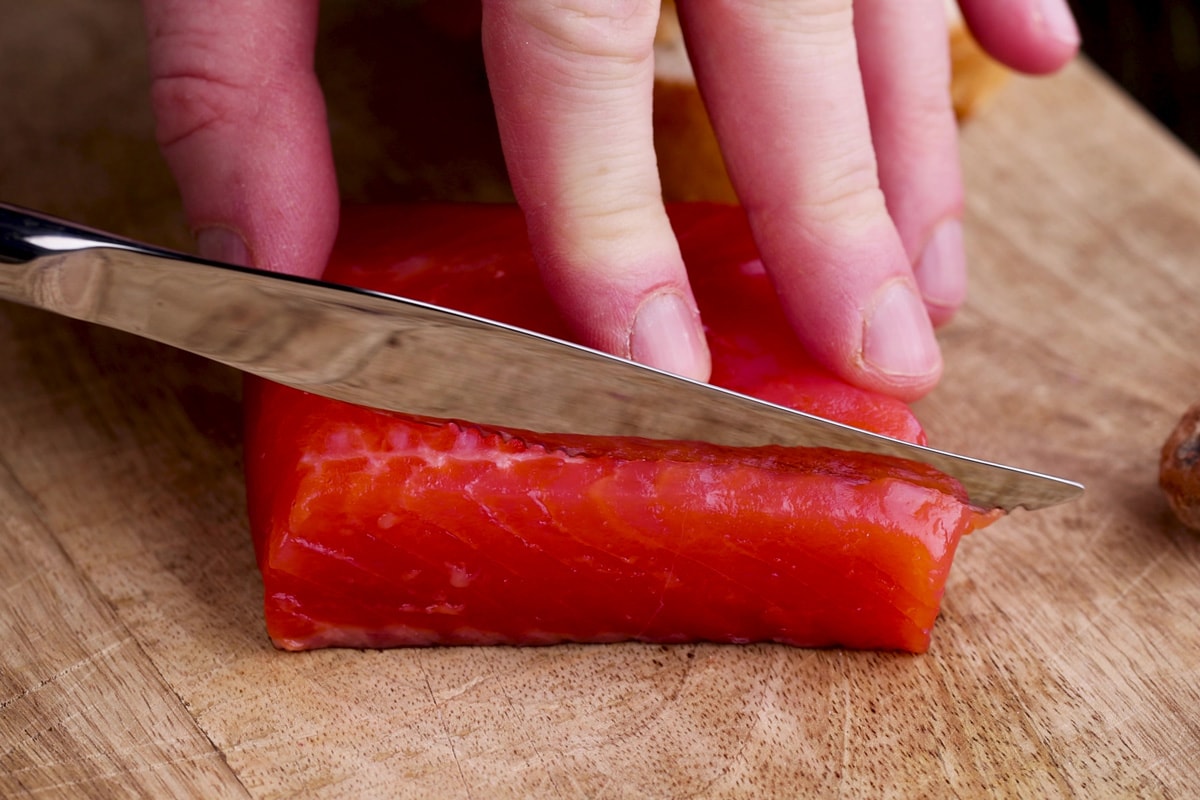 slicing red salted salmon into pieces, the fish is used for cooking and sushi, What Salmon Is Used For Sushi? [These Are The Best Types!]