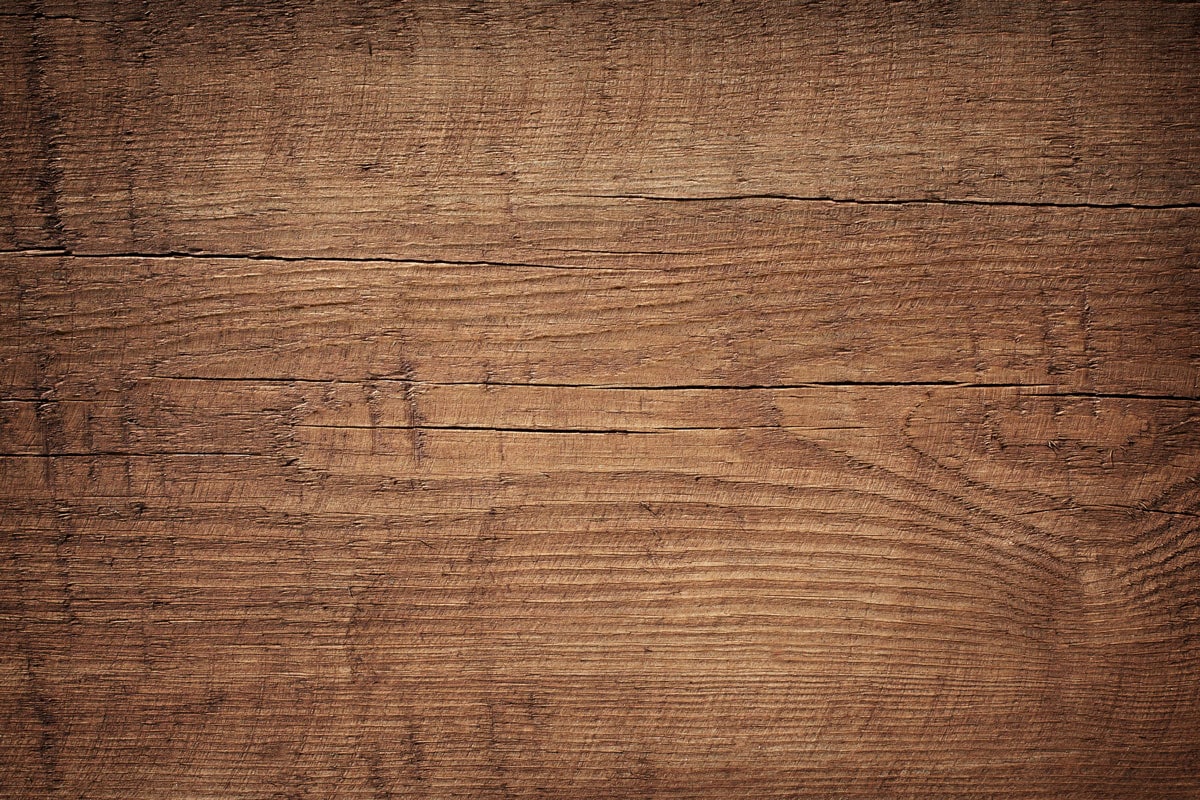 Dark brown scratched wooden cutting board. Wood texture