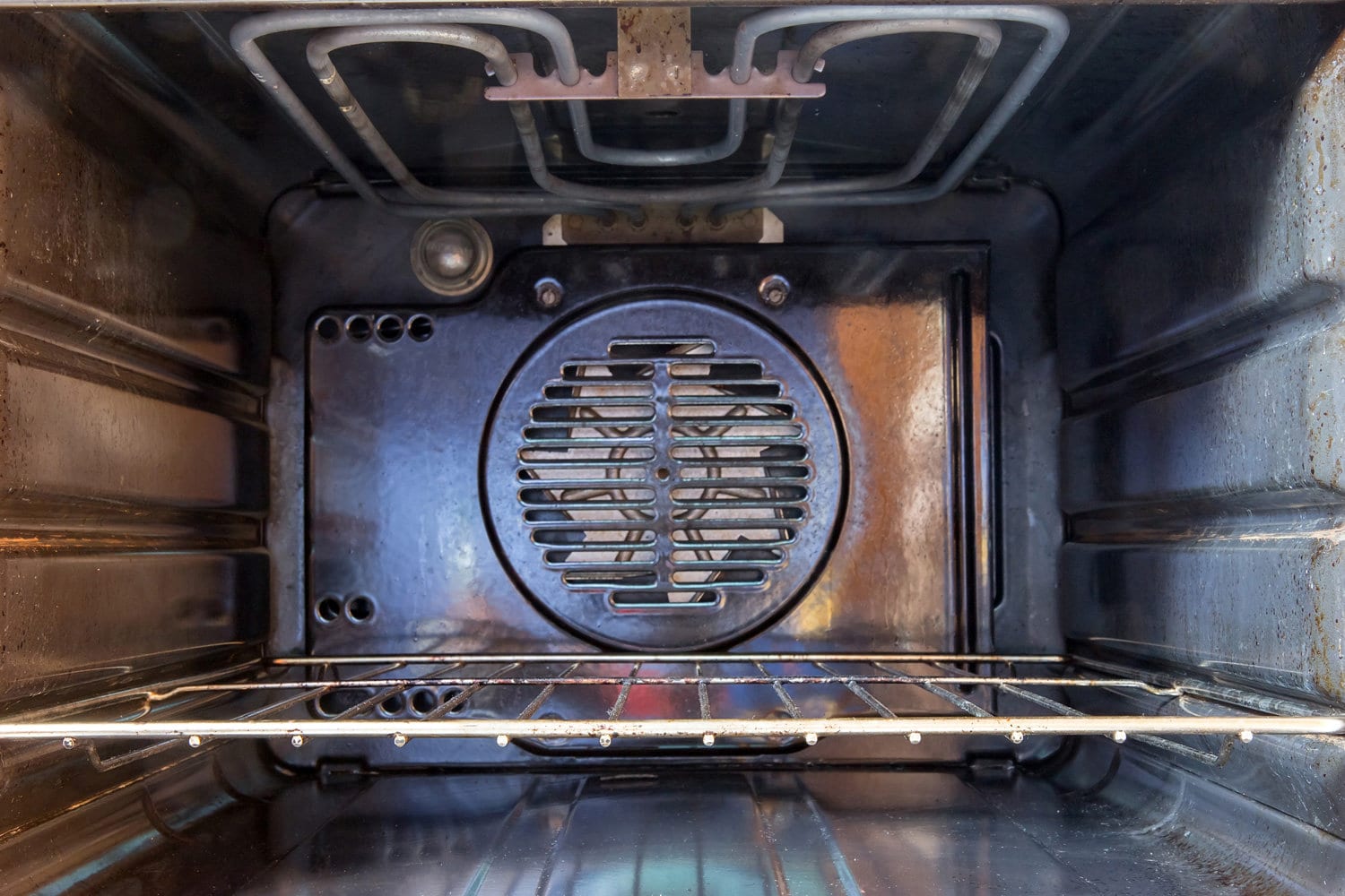 Inner part used electric ovens. Empty electric oven with a ventilator. A close look inside the oven.