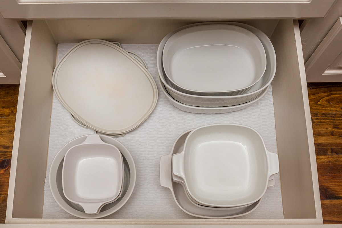 White baking and cooking dishes organized in a drawer