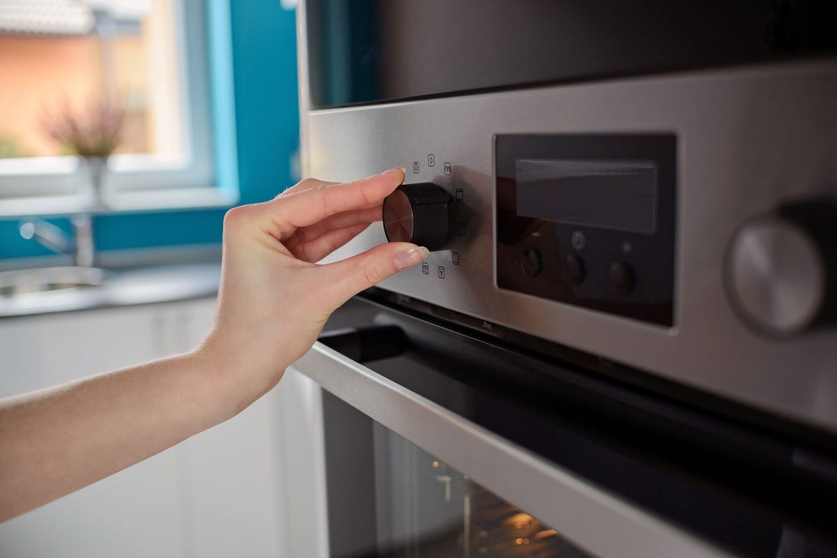 女人调节电炉的温度